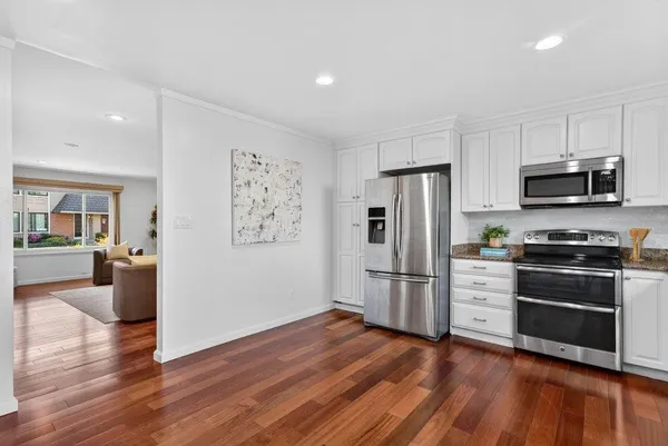 a kitchen with stainless steel appliances a refrigerator stove and microwave