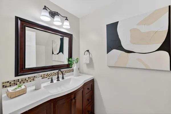 a bathroom with a sink vanity and mirror