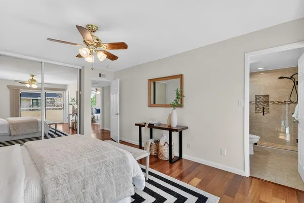 a bedroom with a bed and wooden floor