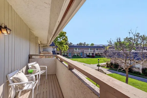 a view of balcony with furniture and city view