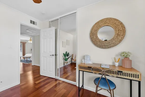 a very nice looking room with wooden floor and a chandelier