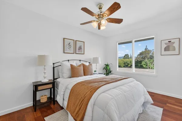 a large bed sitting in a bedroom next to a window