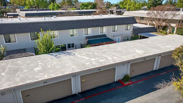 a view of a house with sitting area and a yard