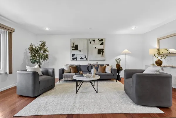 a living room with furniture and a potted plant