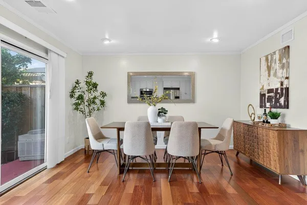 a view of a dining room with furniture and wooden floor