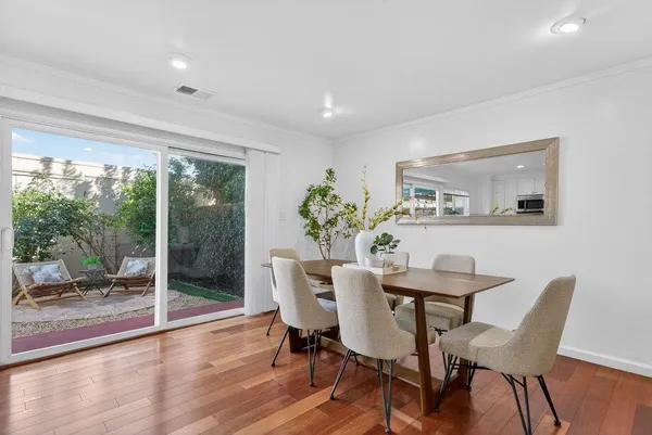 a view of a dining room with furniture and wooden floor