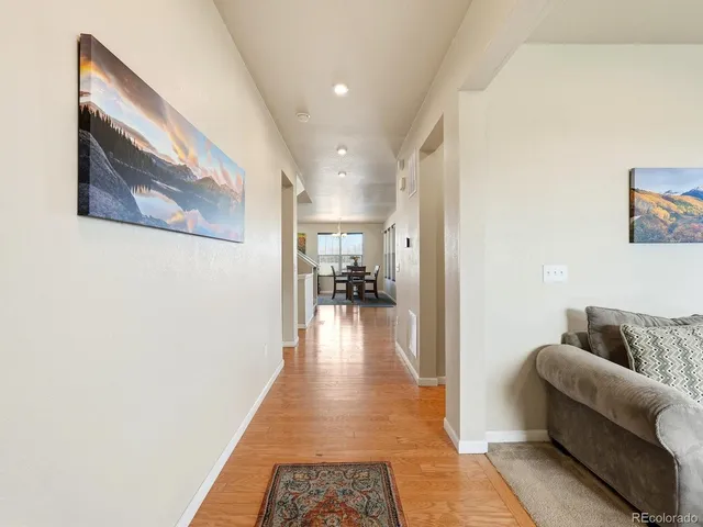 a hallway with furniture and wooden floor