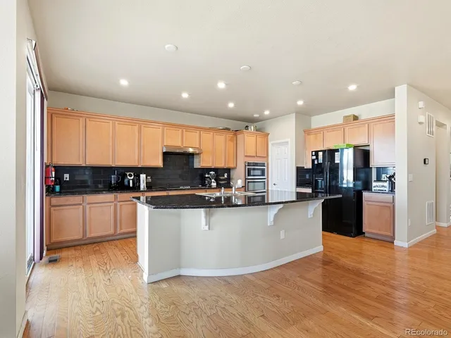 a large kitchen with stainless steel appliances lots of counter top space