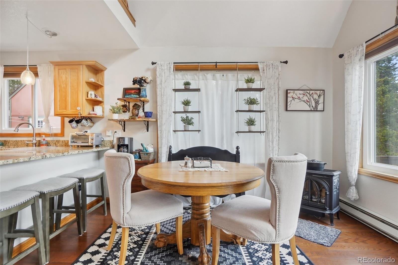 125 Aspen Road Black Hawk, CO 80422 - Photo 10 of 44 a view of a dining room with furniture window and wooden floor