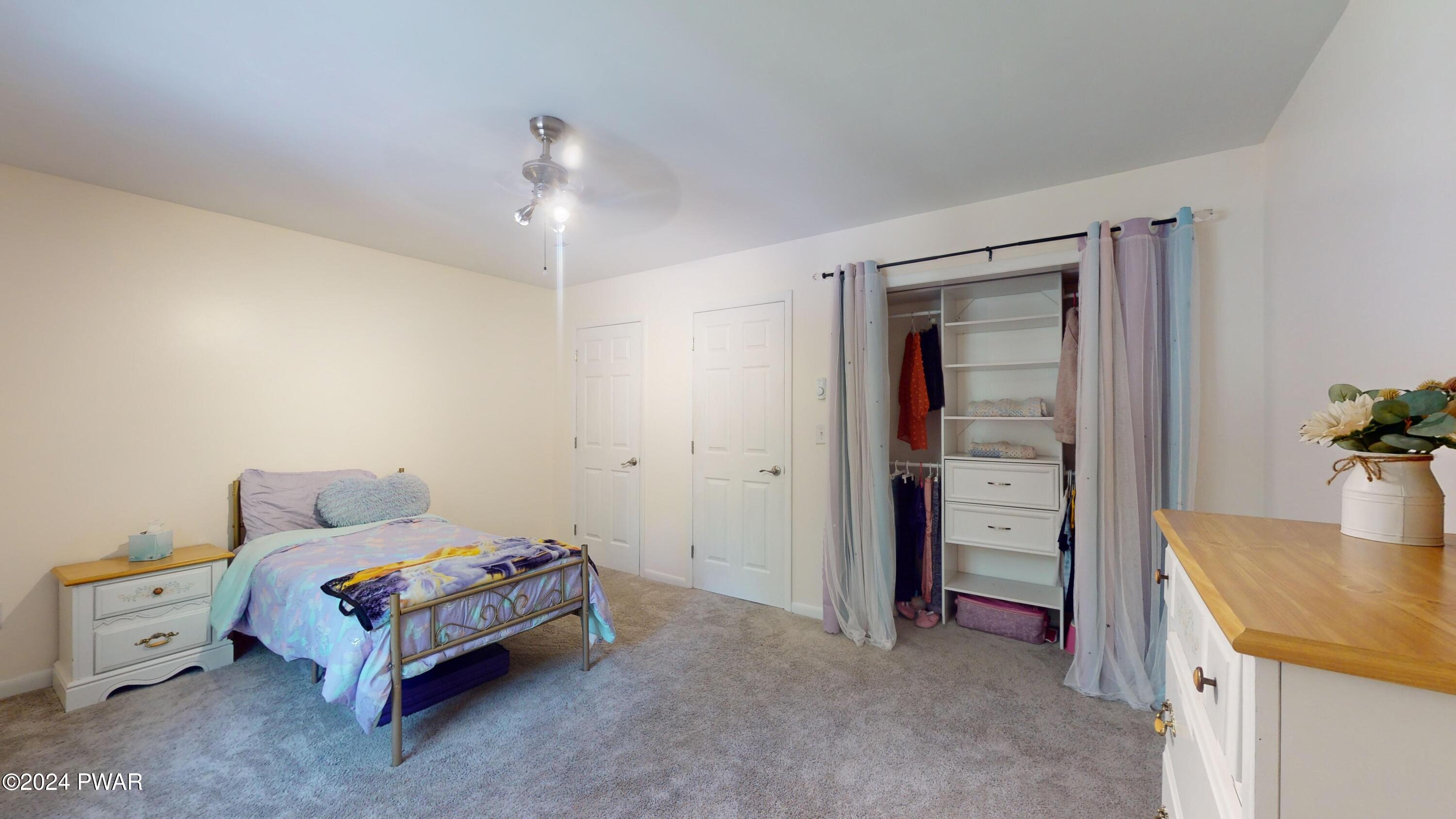 135 Fox Road Dingmans Ferry, PA 18328 - Photo 19 of 24 a bedroom with a bed and a table