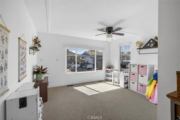 a view of a livingroom with furniture and a ceiling fan