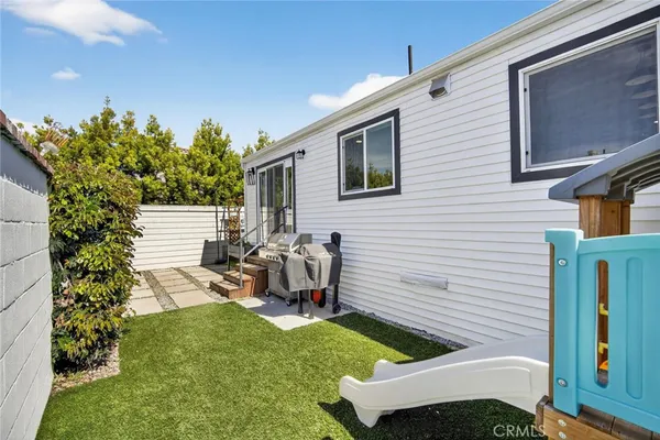 a view of backyard of house with seating space