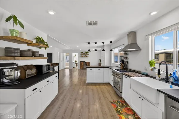 a kitchen with cabinets and wooden floor