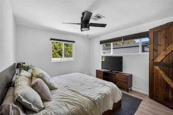 a bedroom with a bed and a flat screen tv