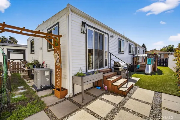a view of house with yard outdoor seating and plants