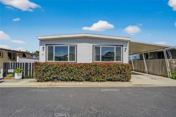 a kitchen with stainless steel appliances kitchen island granite countertop a table chairs and a refrigerator