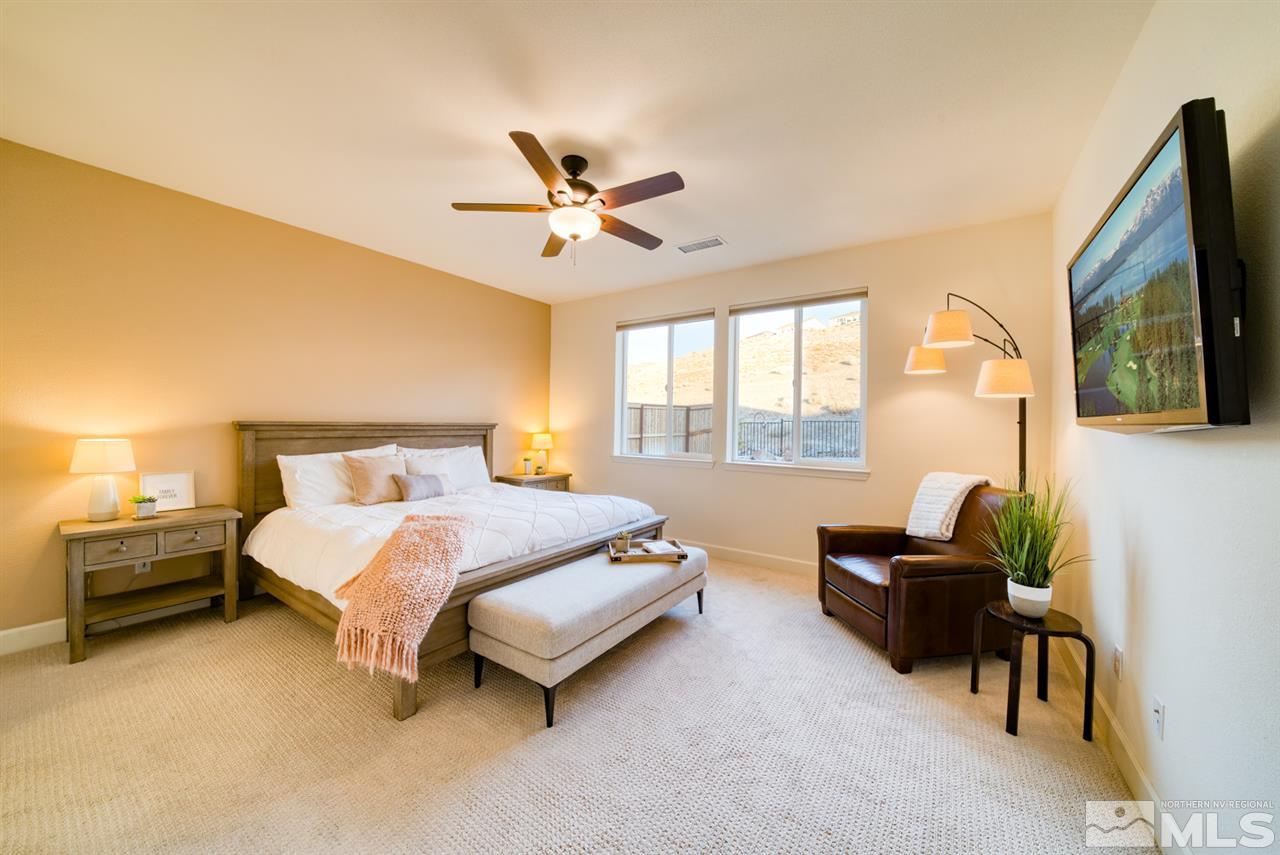 10380 Gold Mine Drive Reno, NV 89521 - Photo 11 of 23 a bedroom with a bed flat screen tv and windows