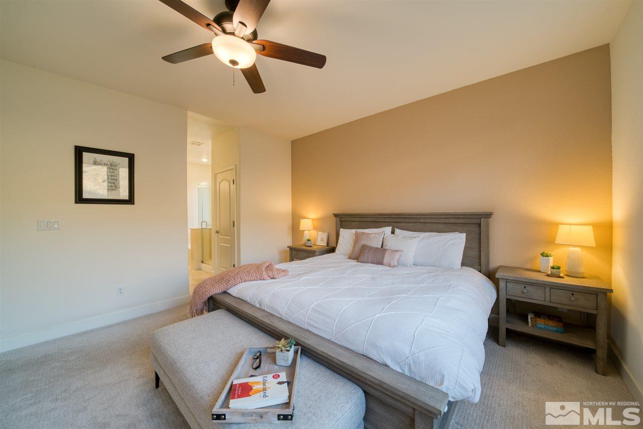 10380 Gold Mine Drive Reno, NV 89521 - Photo 12 of 23 a bedroom with a bed and a chandelier