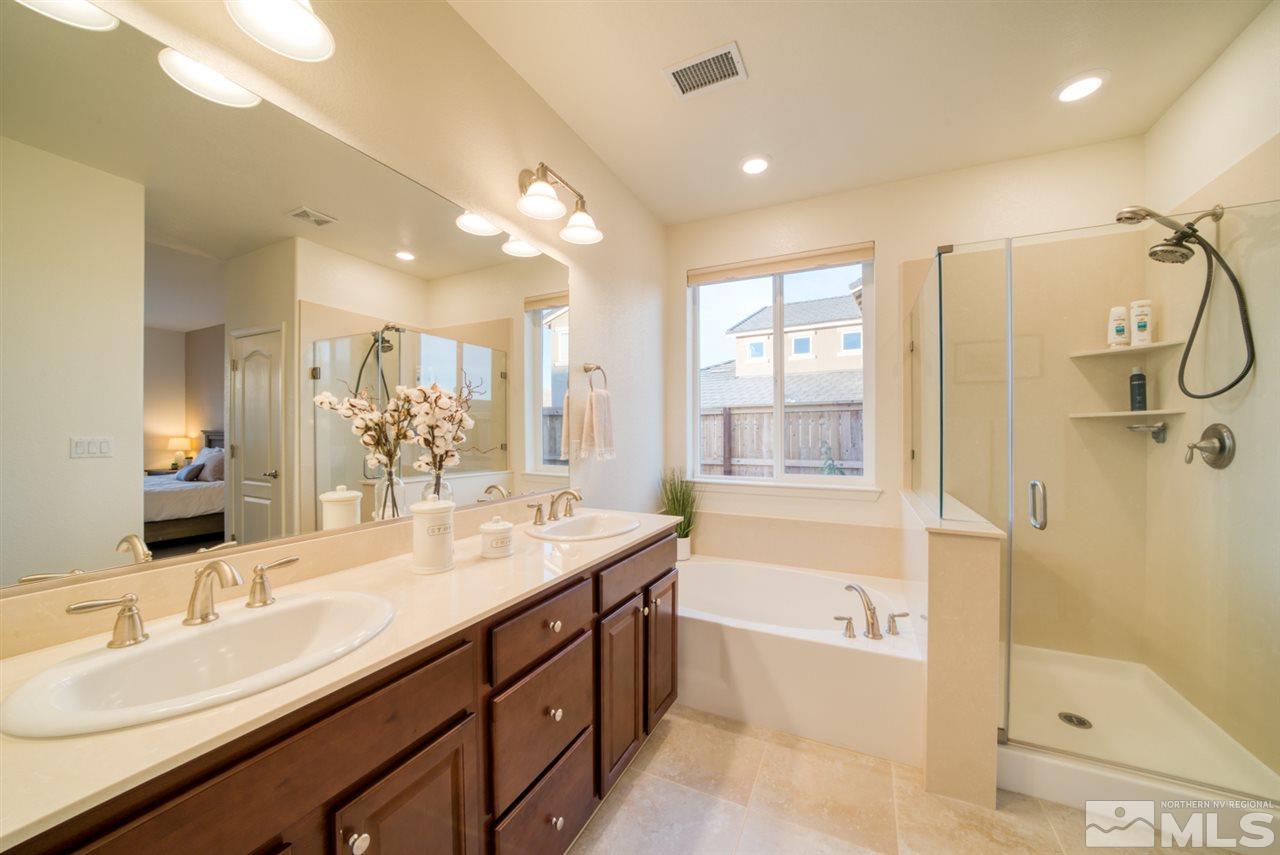 10380 Gold Mine Drive Reno, NV 89521 - Photo 13 of 23 a bathroom with a tub sink double vanity and shower
