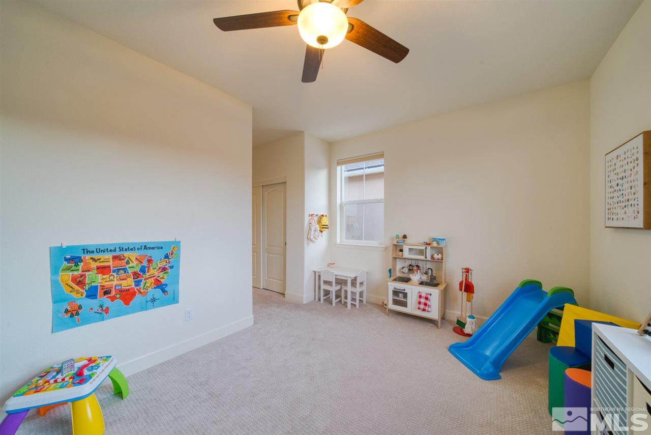 10380 Gold Mine Drive Reno, NV 89521 - Photo 19 of 23 a bedroom with furniture and a book shelf