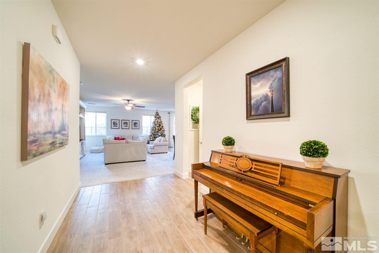 10380 Gold Mine Drive Reno, NV 89521 - Photo 2 of 23 a living room with furniture and paintings on the wall with wooden floor