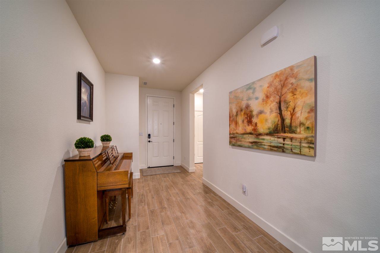 10380 Gold Mine Drive Reno, NV 89521 - Photo 3 of 23 a view of a hallway with wooden floor and a bookshelf