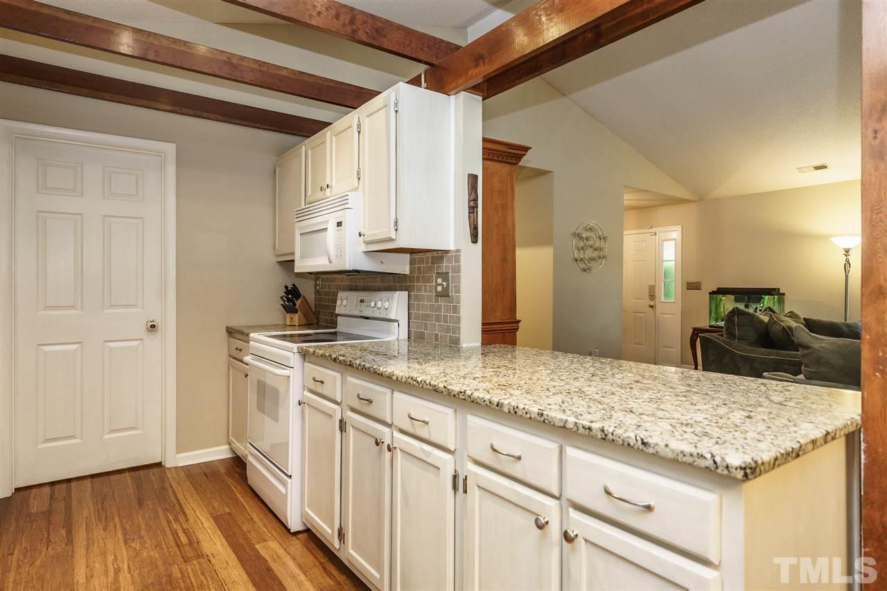 1300 Buckhorn Road Garner, NC 27529 - Photo 13 of 25 a kitchen with stainless steel appliances granite countertop a sink and cabinets