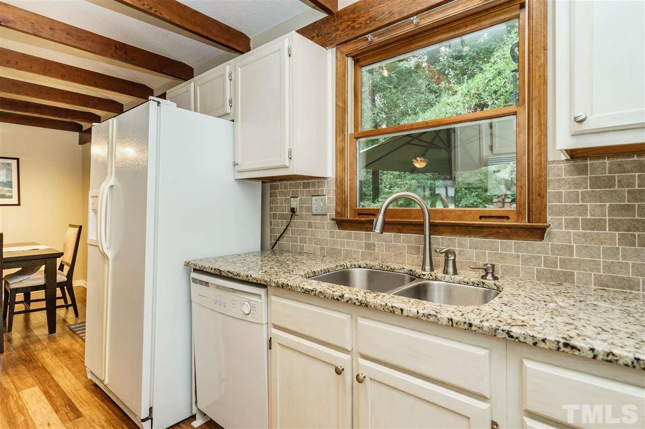 1300 Buckhorn Road Garner, NC 27529 - Photo 14 of 25 a kitchen with stainless steel appliances granite countertop a sink and a cabinets