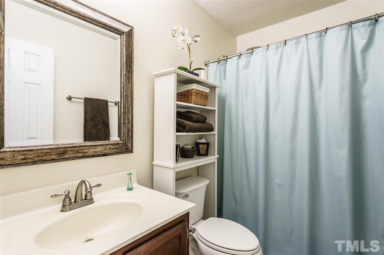1300 Buckhorn Road Garner, NC 27529 - Photo 18 of 25 a bathroom with a sink a toilet and shower