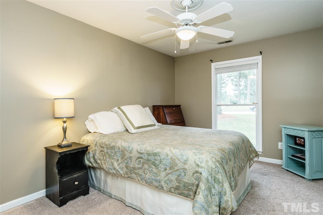 1300 Buckhorn Road Garner, NC 27529 - Photo 19 of 25 a bedroom with a bed and a lamp