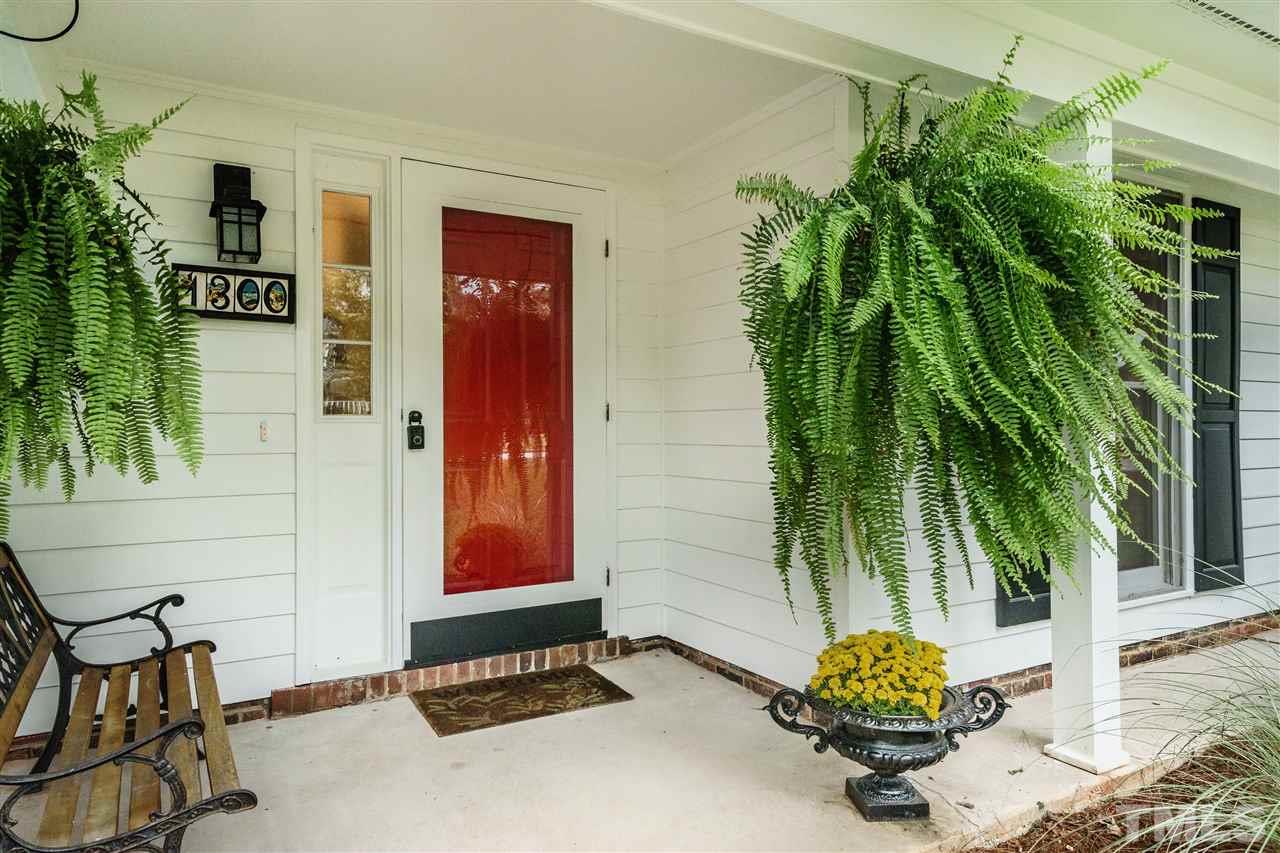 1300 Buckhorn Road Garner, NC 27529 - Photo 3 of 25 a potted plant sitting in front of a house