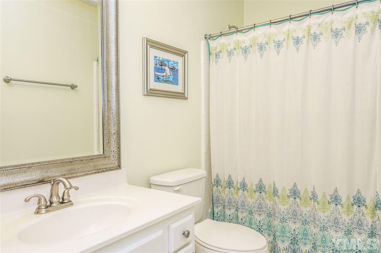 1300 Buckhorn Road Garner, NC 27529 - Photo 21 of 25 a bathroom with a sink a toilet and shower curtain
