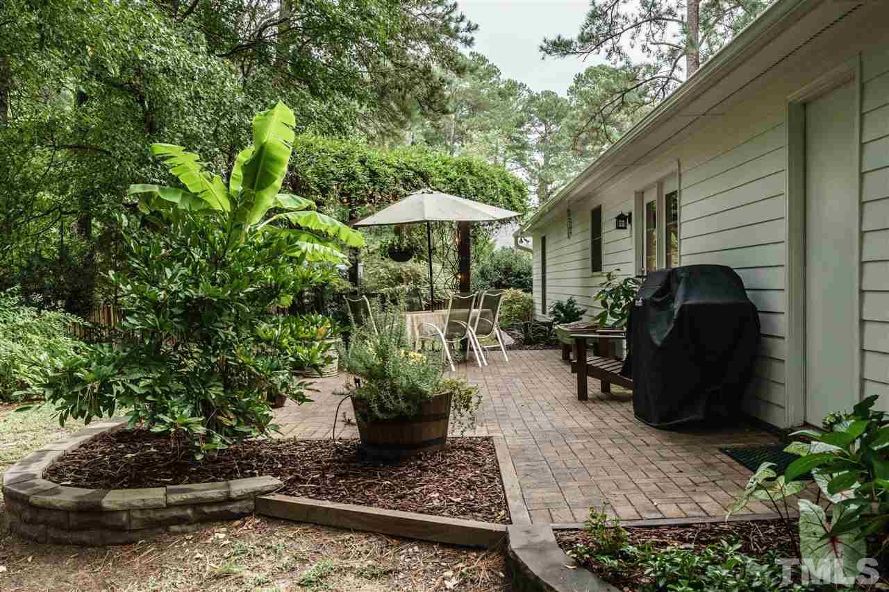 1300 Buckhorn Road Garner, NC 27529 - Photo 24 of 25 a view of a backyard with furniture potted plants and large tree