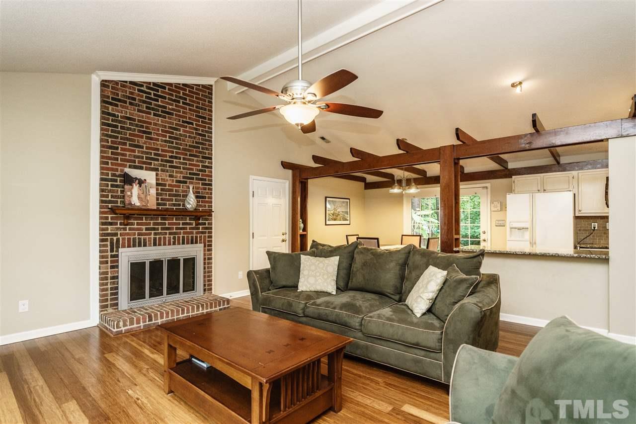 1300 Buckhorn Road Garner, NC 27529 - Photo 9 of 25 a living room with furniture and a fireplace