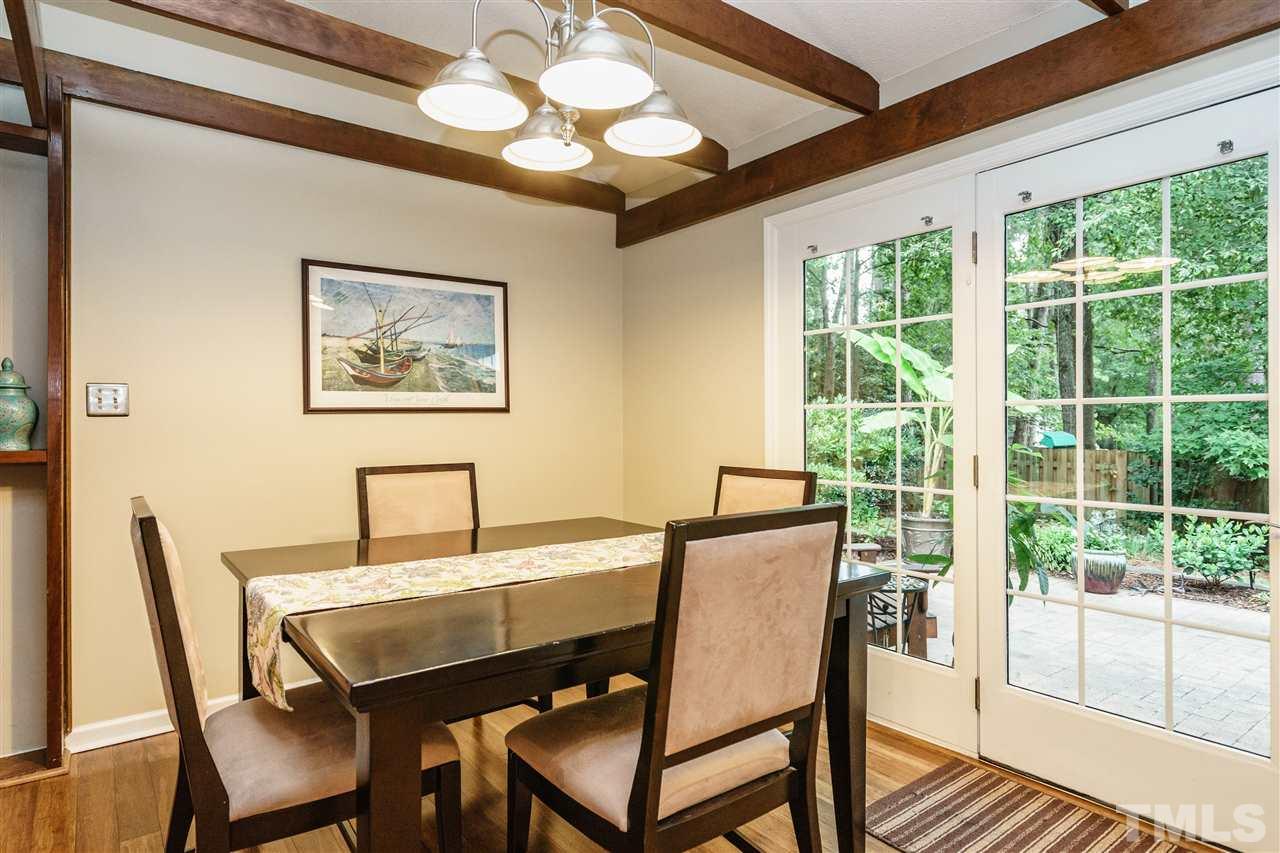 1300 Buckhorn Road Garner, NC 27529 - Photo 10 of 25 a view of a dining room with furniture wooden floor and a chandelier