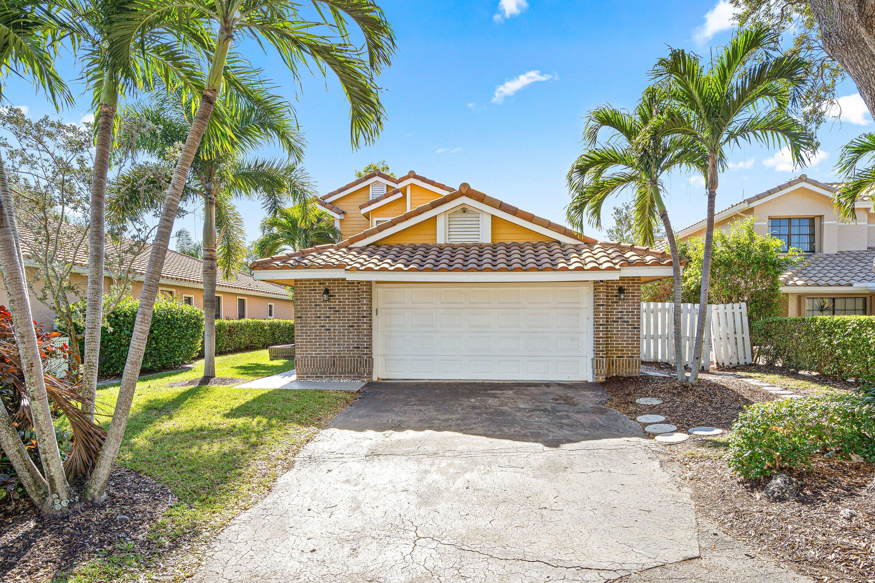 4134 Northwest 2nd Lane Delray Beach, FL 33445 - Photo 1 of 28 a front view of a house with a yard and potted plants