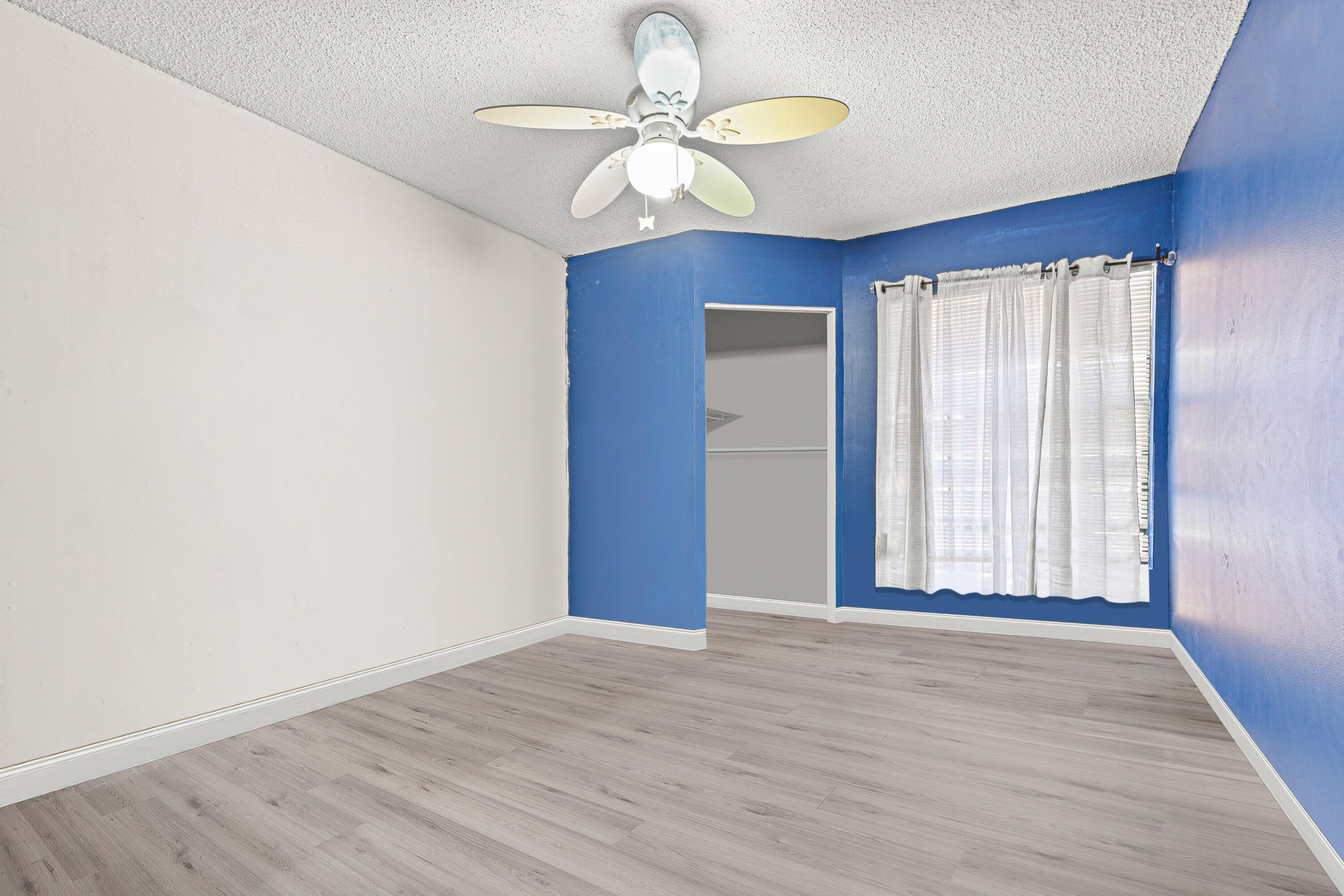 4134 Northwest 2nd Lane Delray Beach, FL 33445 - Photo 21 of 28 an empty room with wooden floor chandelier fan and windows