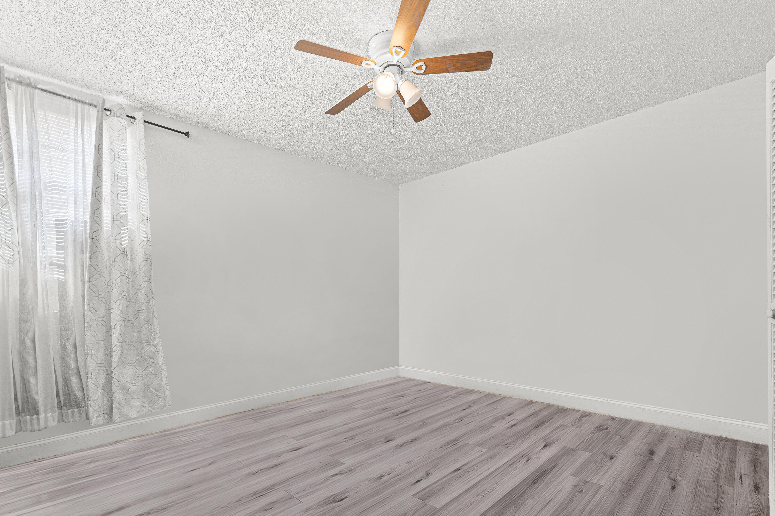 4134 Northwest 2nd Lane Delray Beach, FL 33445 - Photo 22 of 28 a view of an empty room with wooden floor and a window