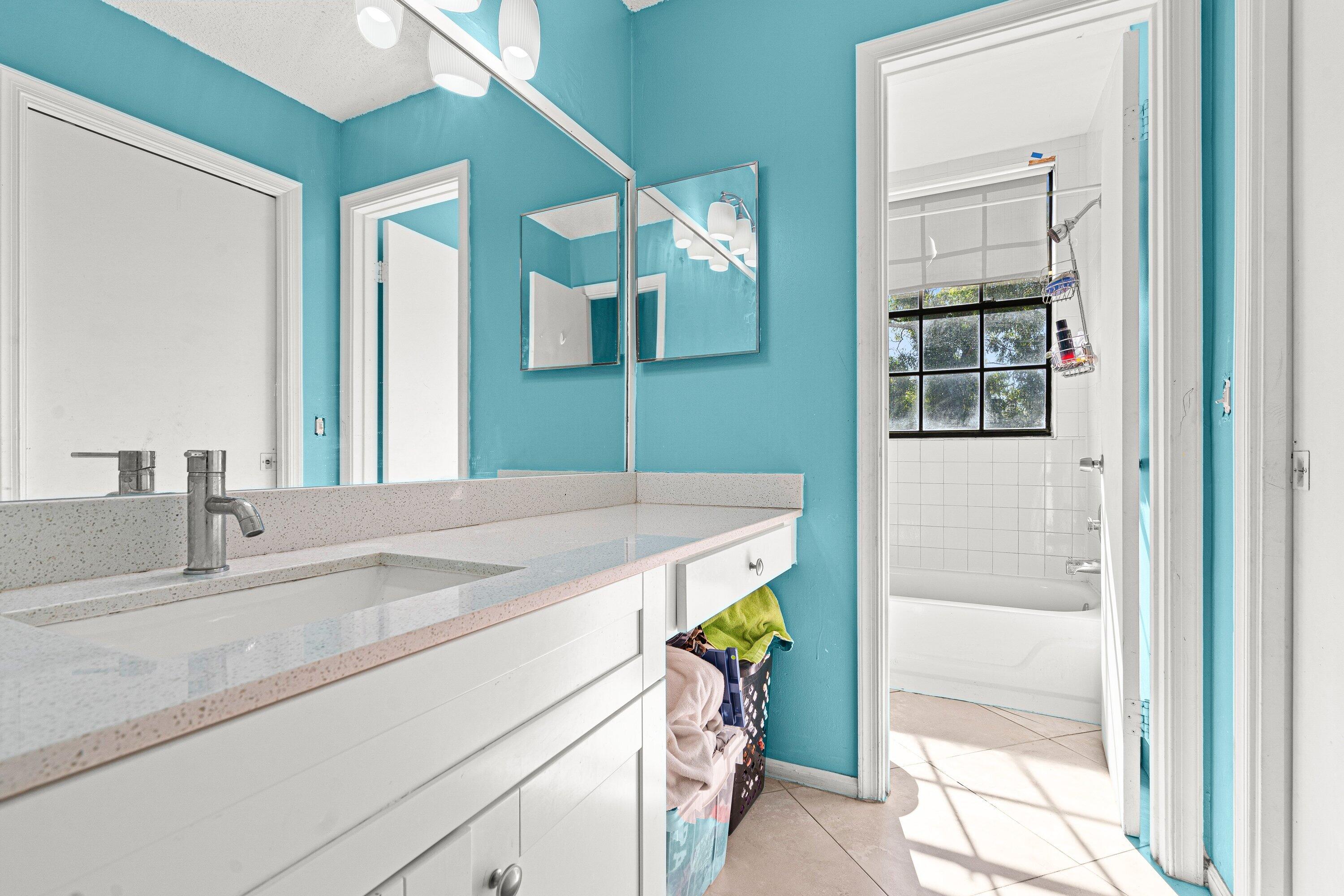 4134 Northwest 2nd Lane Delray Beach, FL 33445 - Photo 25 of 28 a bathroom with a sink and a mirror