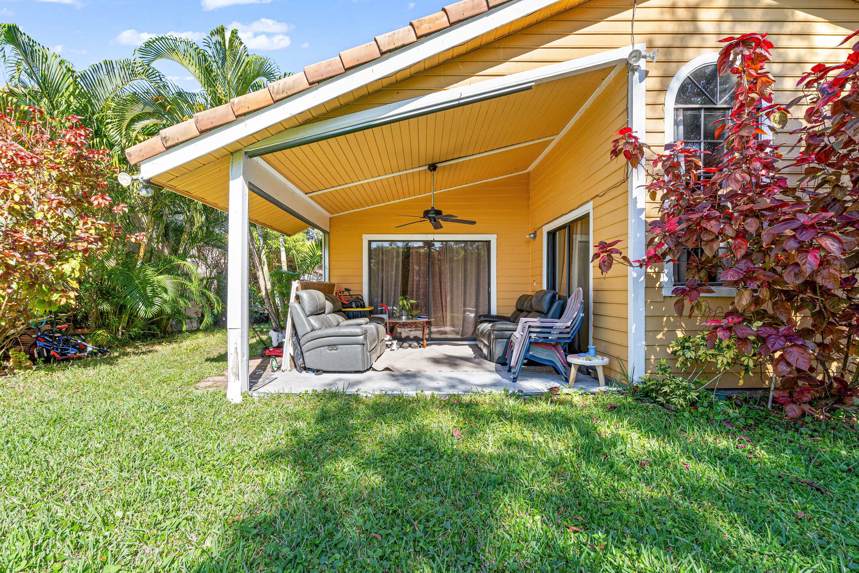4134 Northwest 2nd Lane Delray Beach, FL 33445 - Photo 26 of 28 a view of a backyard with sitting area and slide