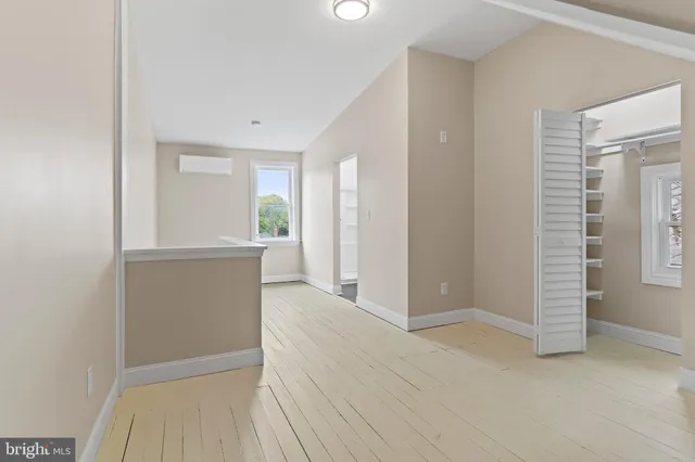 an empty room with windows and closet