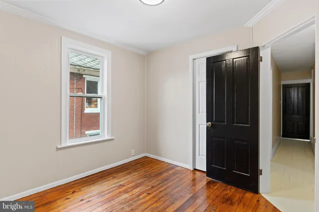 an empty room with closet and windows