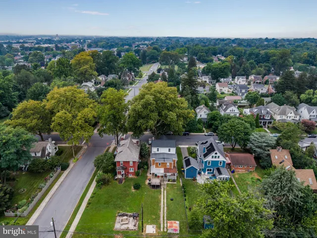 an aerial view of residential houses with outdoor space and river