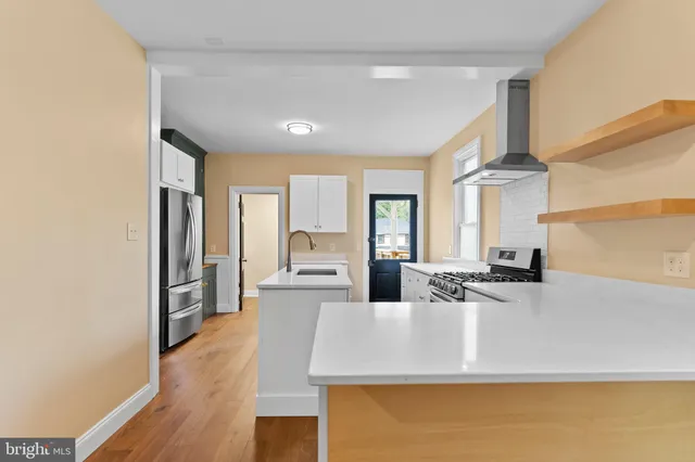 a kitchen with kitchen island a sink appliances and a counter top space
