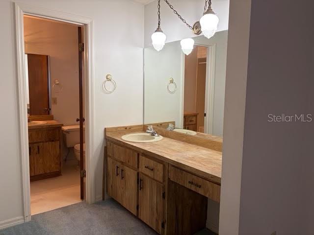 1638 Lamplighter Way Orlando, FL 32818 - Photo 15 of 25 a bathroom with a granite countertop sink and a mirror
