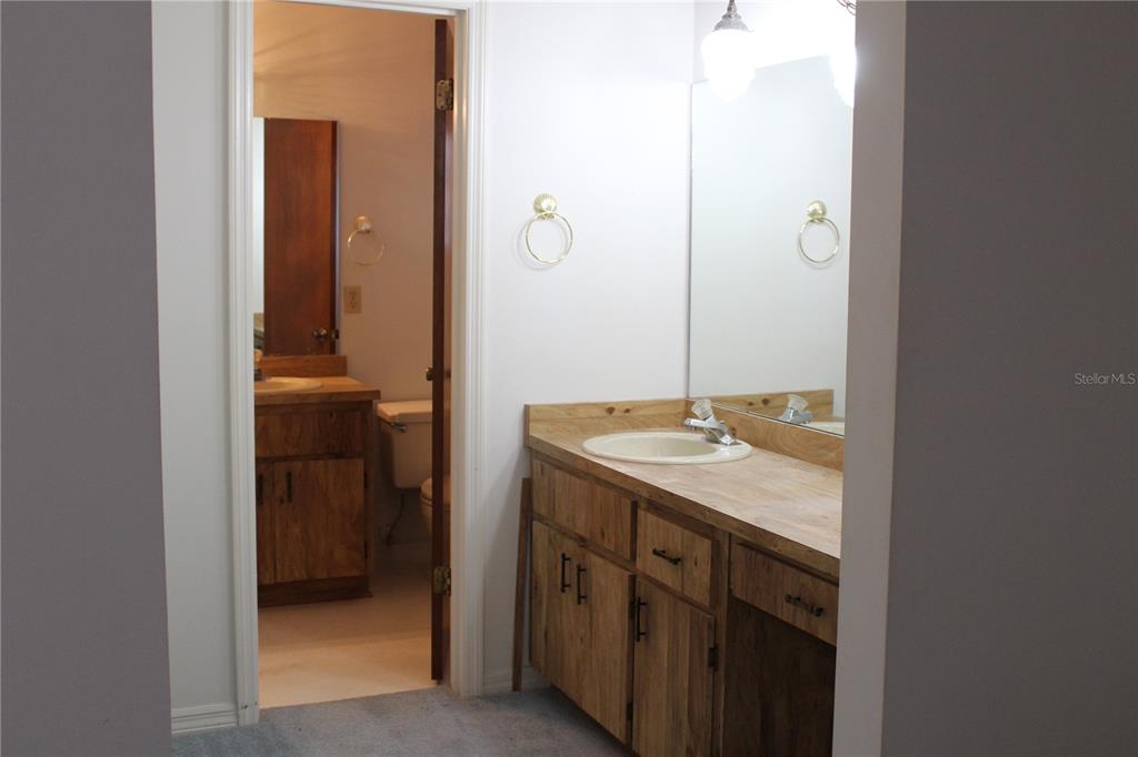 1638 Lamplighter Way Orlando, FL 32818 - Photo 16 of 25 a bathroom with a granite countertop sink and a mirror