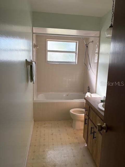 1638 Lamplighter Way Orlando, FL 32818 - Photo 20 of 25 a bathroom with a granite countertop bathtub shower sink vanity and toilet