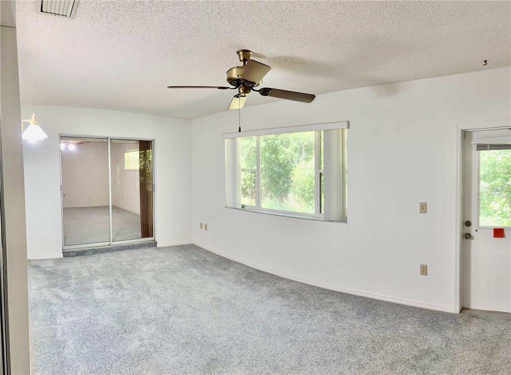 1638 Lamplighter Way Orlando, FL 32818 - Photo 21 of 25 an empty room with windows and fan