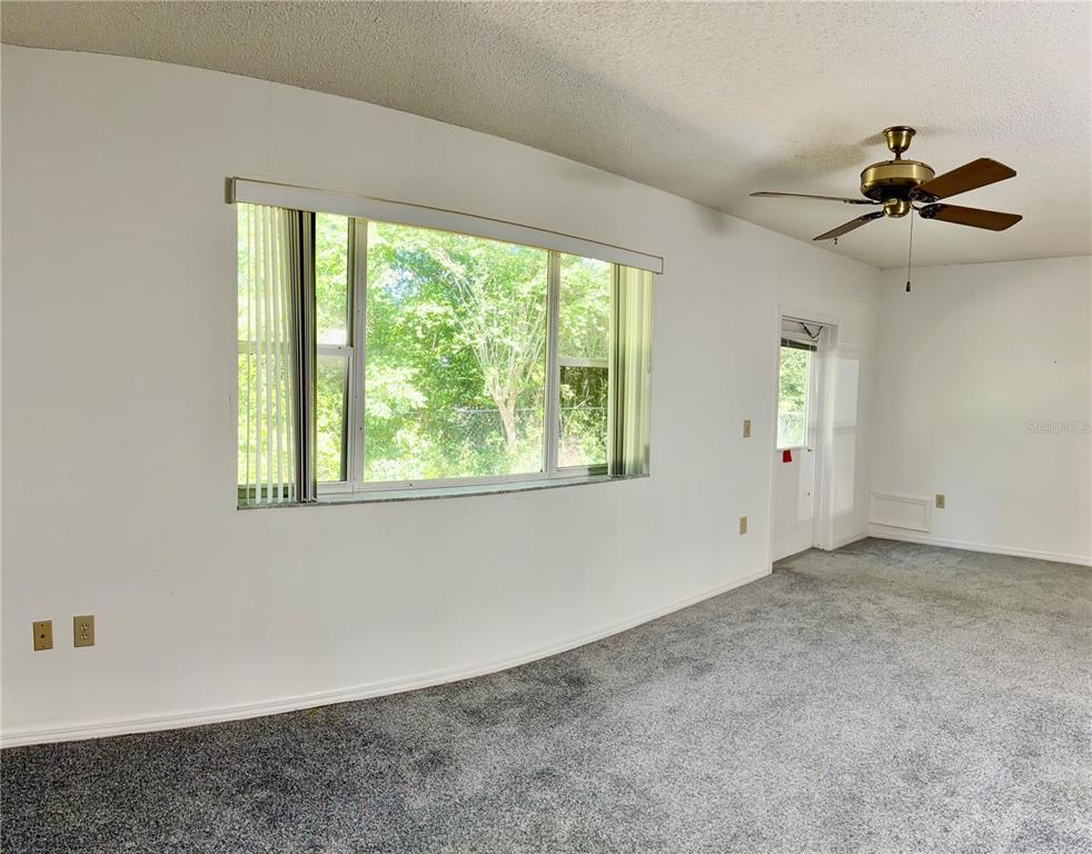 1638 Lamplighter Way Orlando, FL 32818 - Photo 23 of 25 a view of a livingroom with a ceiling fan and window
