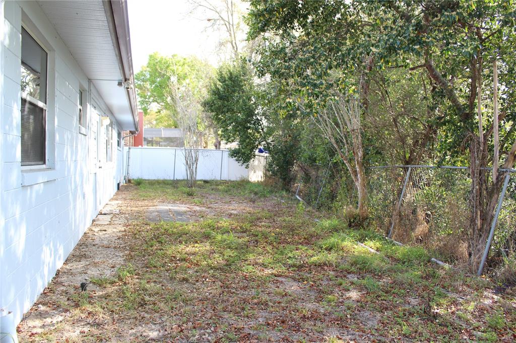 1638 Lamplighter Way Orlando, FL 32818 - Photo 24 of 25 a view of a house with a backyard